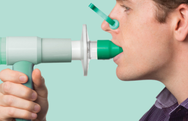 a man using a device to use a breathing device